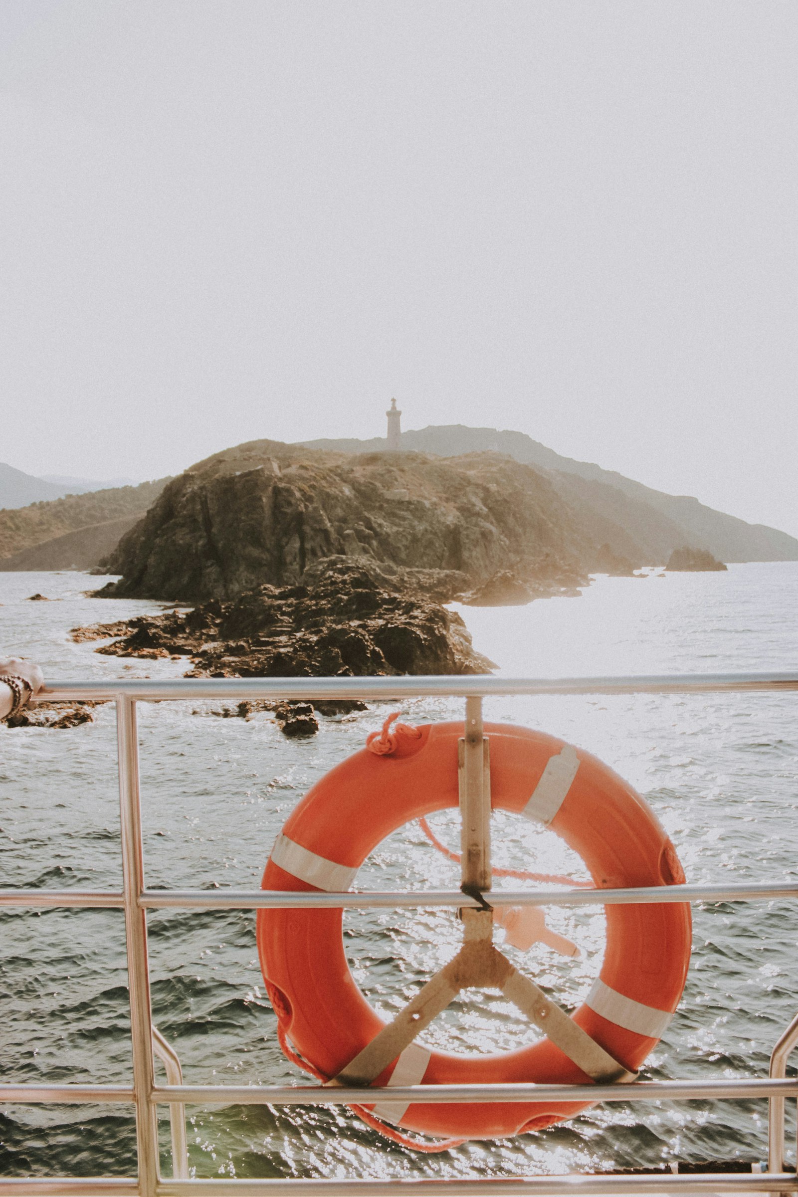 An orange life ring mounted on a ship's railing